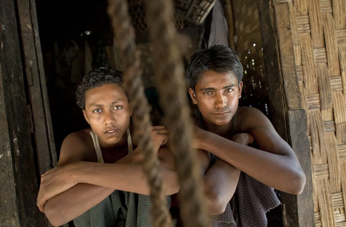 In this Monday, May 11, 2015, photo 16-year-old Sadik Hussein, left, and 17-year-old Noor Alam, hours after returning to their homes in Thetkabyin Village, north of Sittwe, western Rakhine state, Myanmar.  (AP Photo/Gemunu Amarasinghe)
