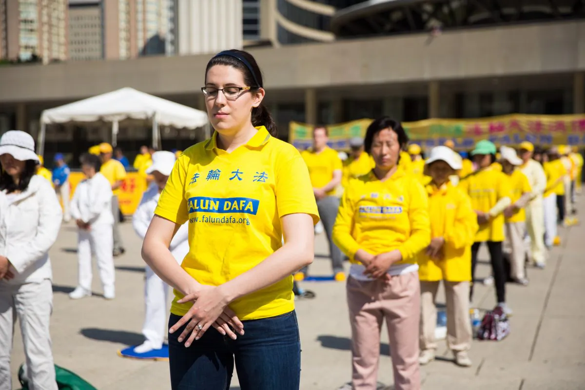 A young woman practices Falun Dafa exercises on Nathan Phillips Square, May 17.(Evan Ning/Epoch Times)