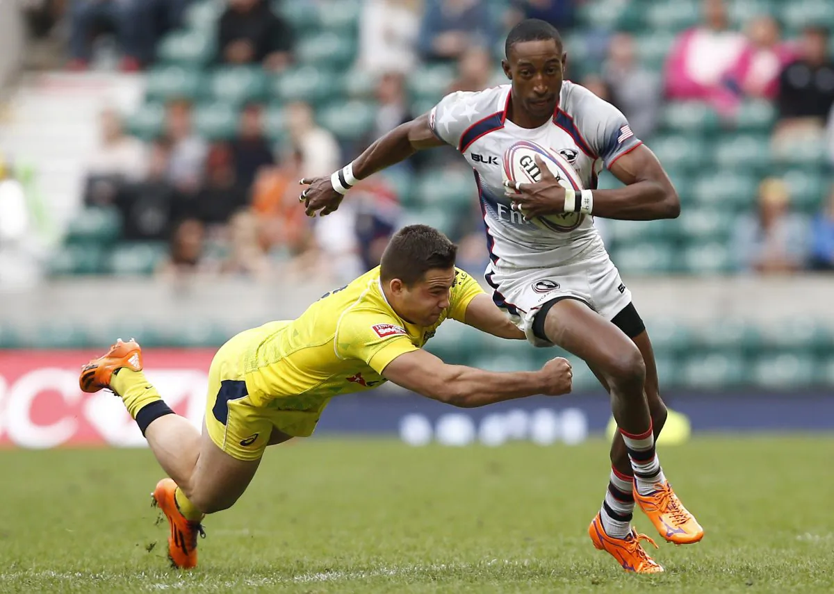 Australia's Greg Jeloudev (L) misses a tackle on US's Perry Baker during the London Sevens rugby union cup final match between USA and Australia, part of the IRB Sevens World Series, at Twickenham Stadium in London on May 17, 2015. (Justin Tallis/AFP/Getty Images)
