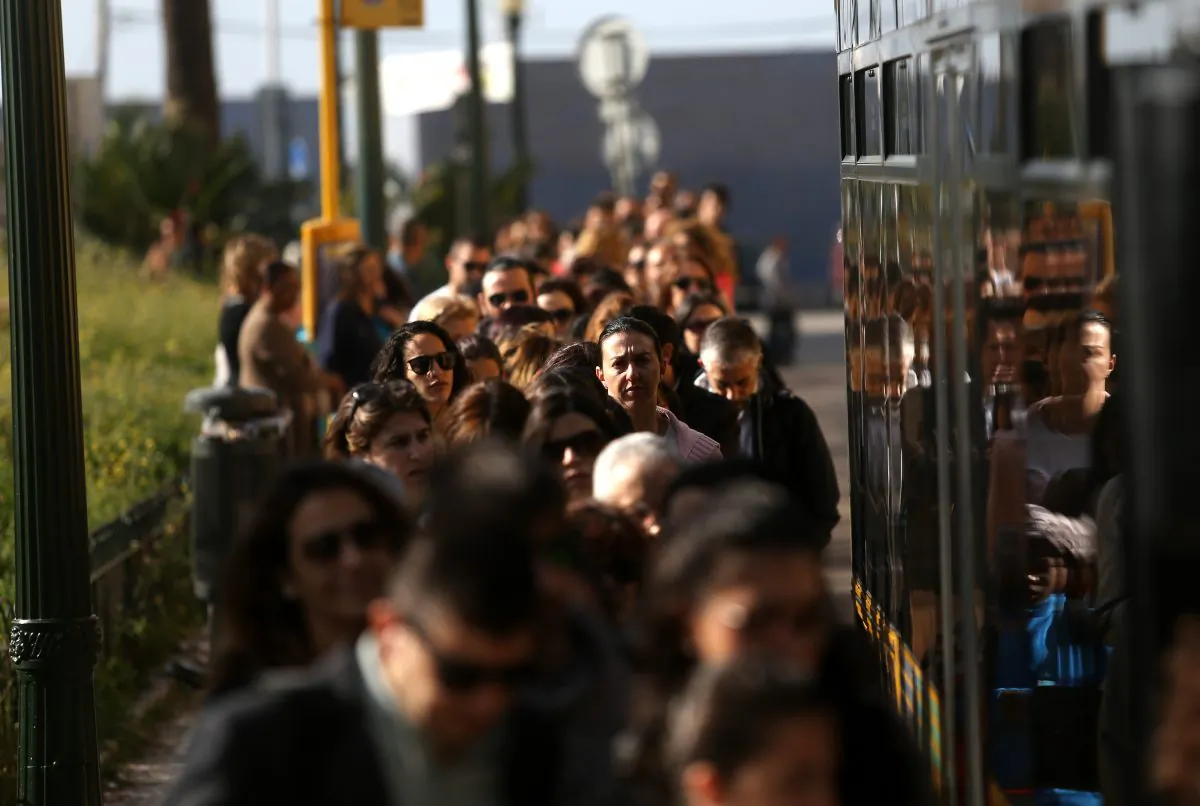 Commuters queue to board a bus during a 24-hour strike by Lisbon's subway workers, in Lisbon, Portugal, Tuesday, May 19, 2015. The strike was against pay cuts and the public company's possible privatisation. (AP Photo/Francisco Seco)