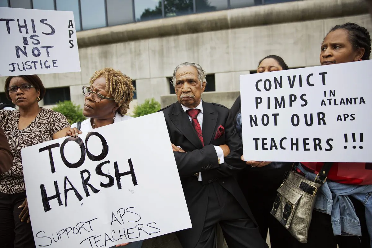 Supporters of former Atlanta public school educators who were sentenced in a cheating scandal attend a vigil outside Fulton County Superior Court, Tuesday, April 14, in Atlanta. Eric Anderman argues that the motivations for cheating can be reduced if teachers and students focus on mastery. (AP Photo/David Goldman) 