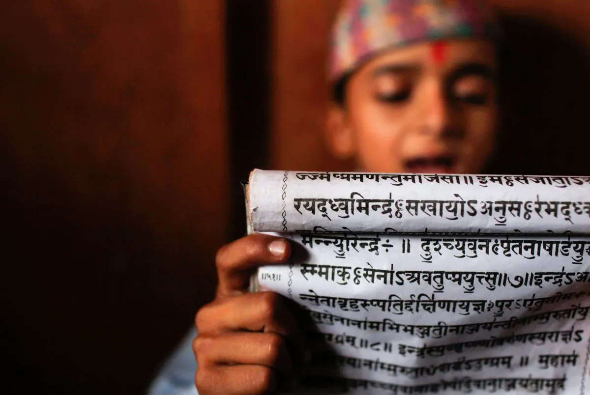 A young student reads Sanskrit scripts while attending class at Budhanilkantha Vedh Vidhya ashram, a school imparting vedic knowledge in Katmandu, Nepal, on June 13, 2013. (AP Photo/Niranjan Shrestha)
