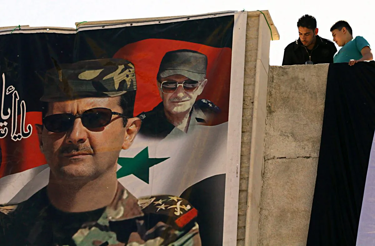 A poster of Syrian President Bashar al-Assad (L) and his late father and predecessor Hafez al-Assad in Damascus on May 1. (Louai Beshara/AFP/Getty Images) 
