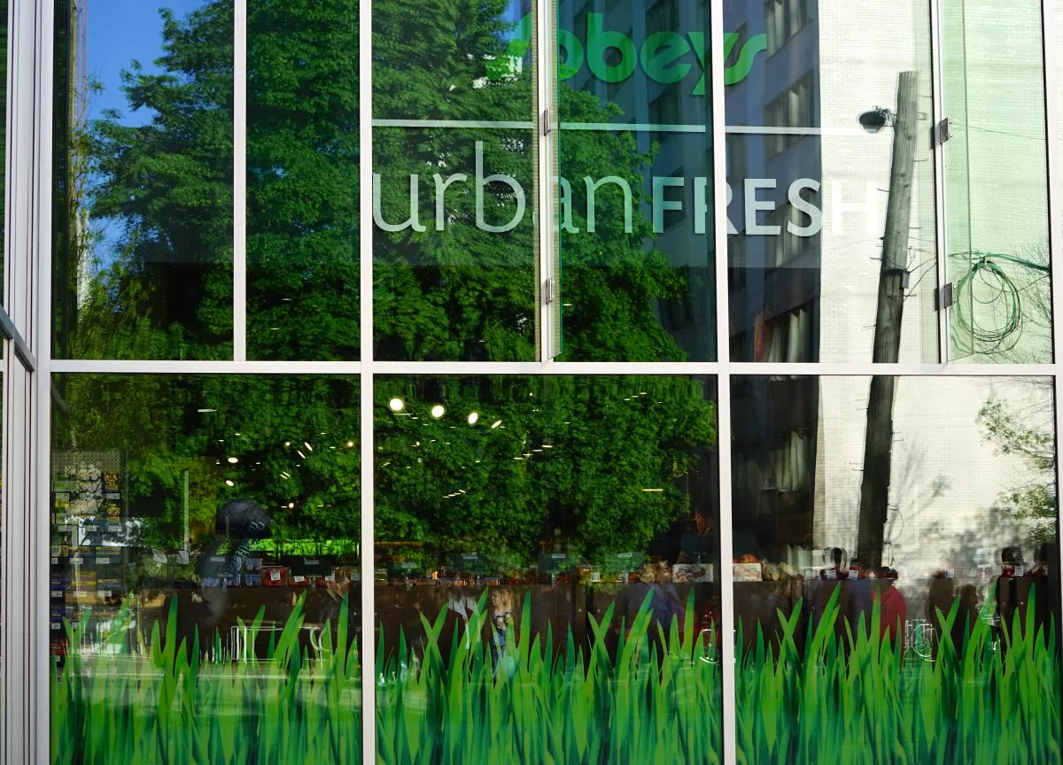 Reflected sign in window of the new downtown Ottawa Sobeys store, May 22, 2015. (Pam McLennan/Epoch Times)