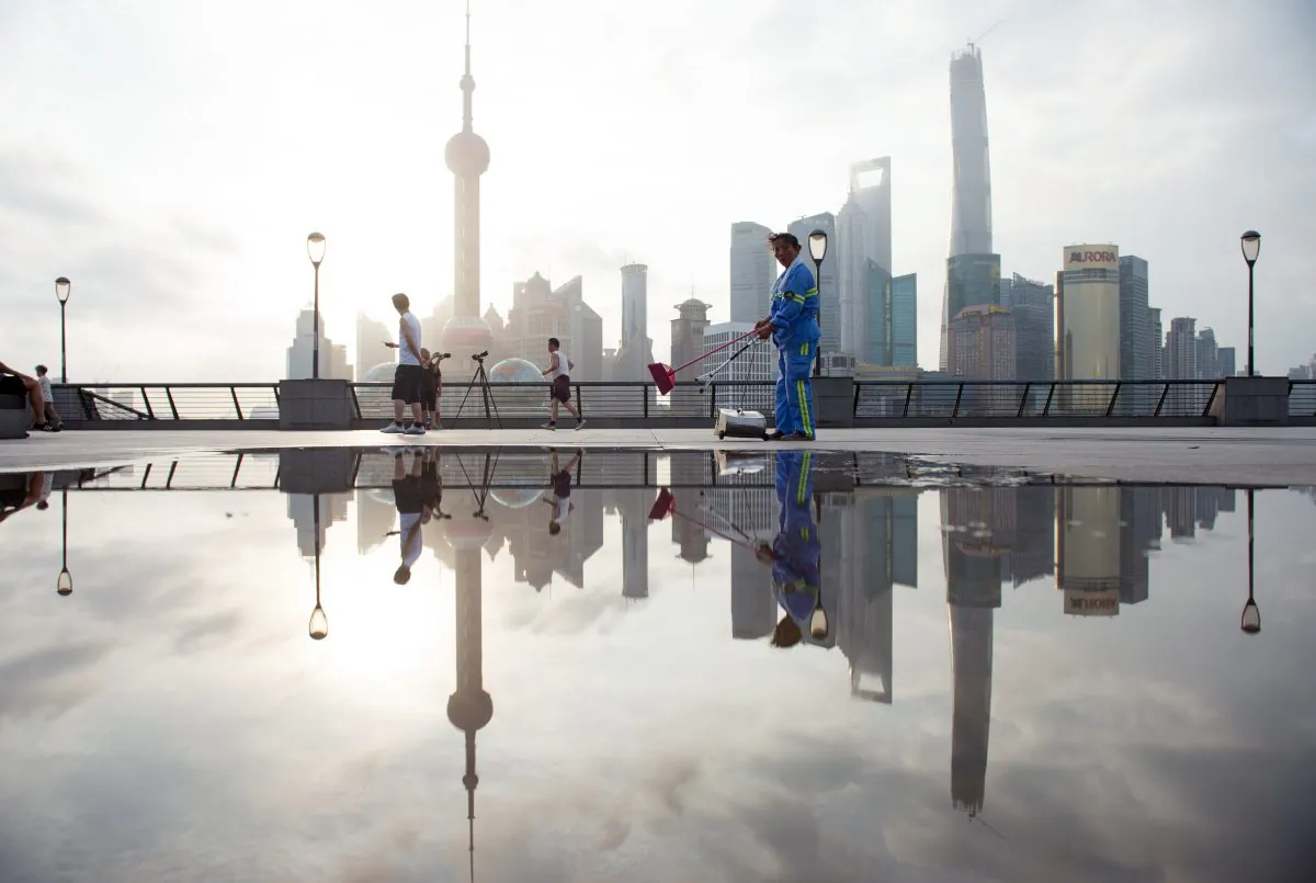 A worker cleans the promenade in Shanghai on July 24, 2014. (Johannes Eisele/AFP/Getty Images)