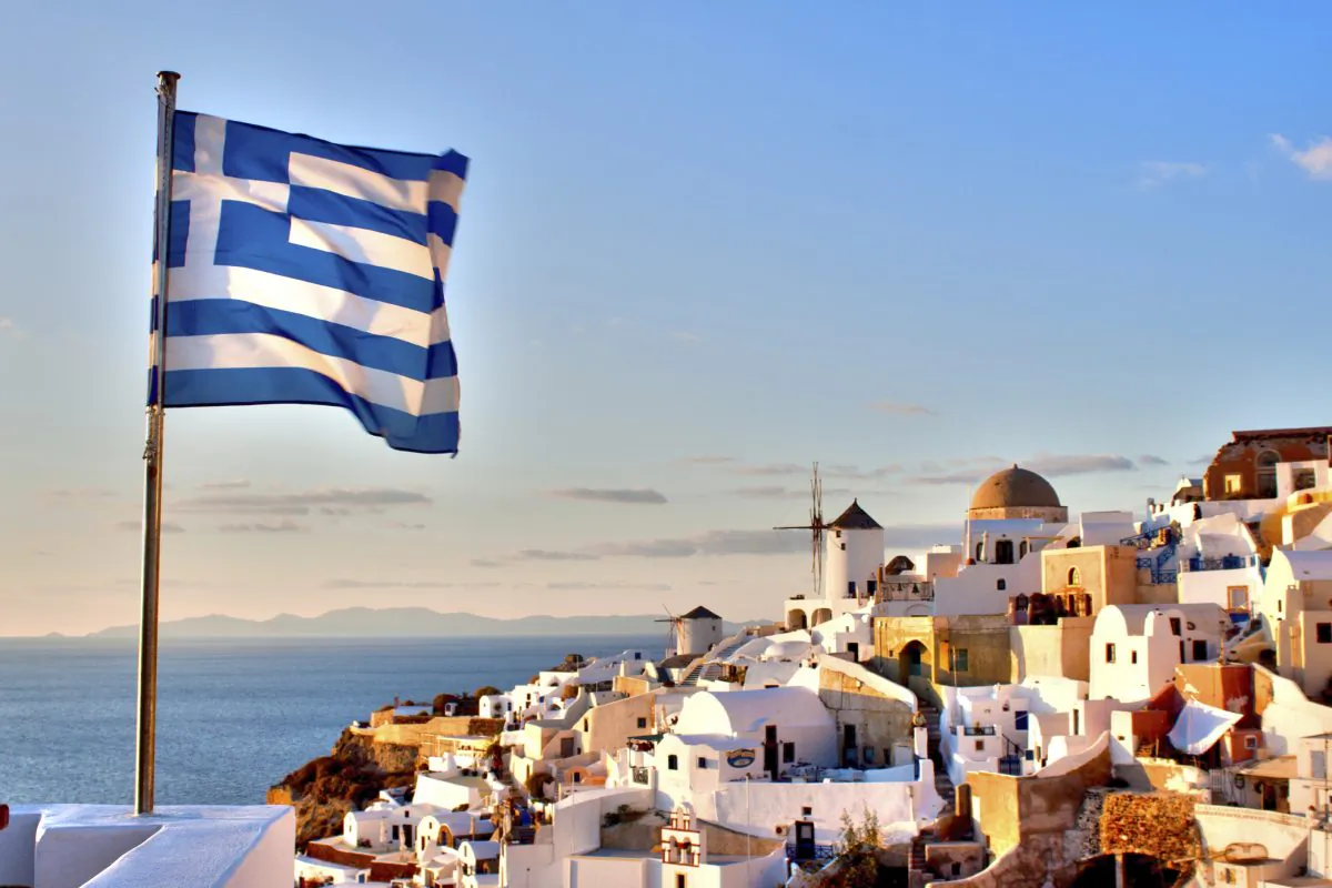 Greek Flag over Oia (StephanieSutherlinPhotography, iStock)
