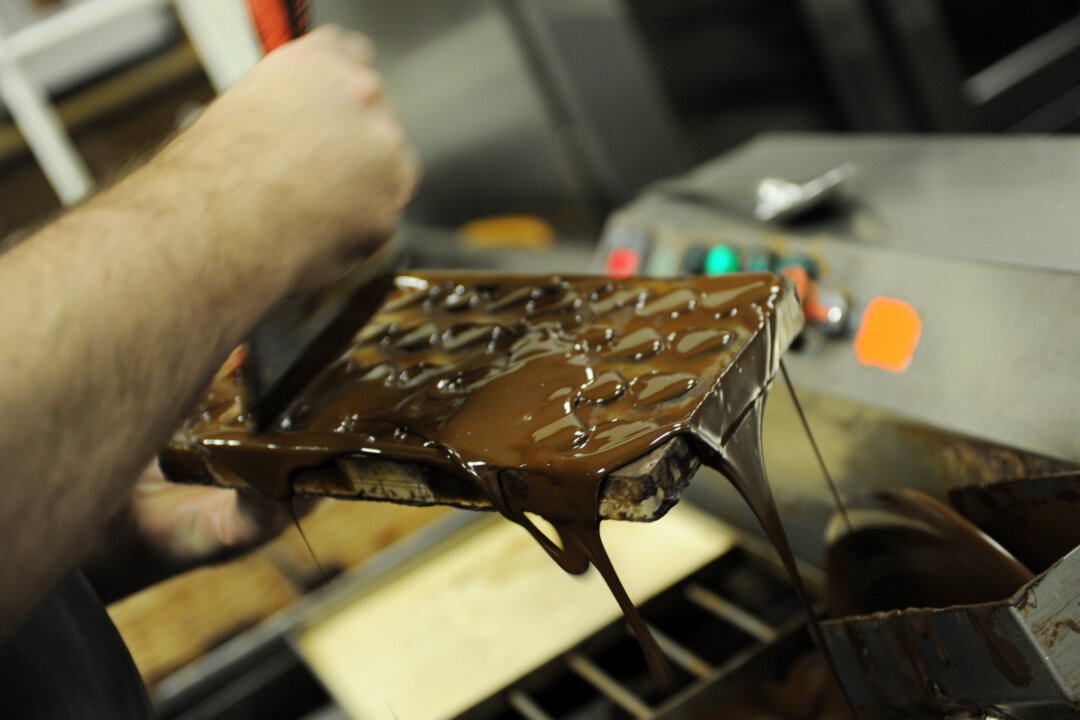 Executive pastry chef Torben Bang ladles dark chocolate into a mold February 4, 2011 at Knipschildt Chocolatier in Norwalk, Connecticut.(Stan Honda/AFP/Getty Images)