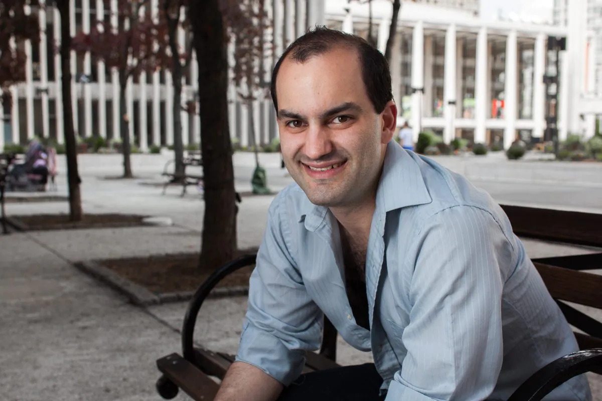 Tenor, Theo Lebow poses for a photo at Damrosch Park next to the Metropolitan Opera Hours in Lincoln Center, New York on May 12, 2015. (Petr Svab/Epoch Times)