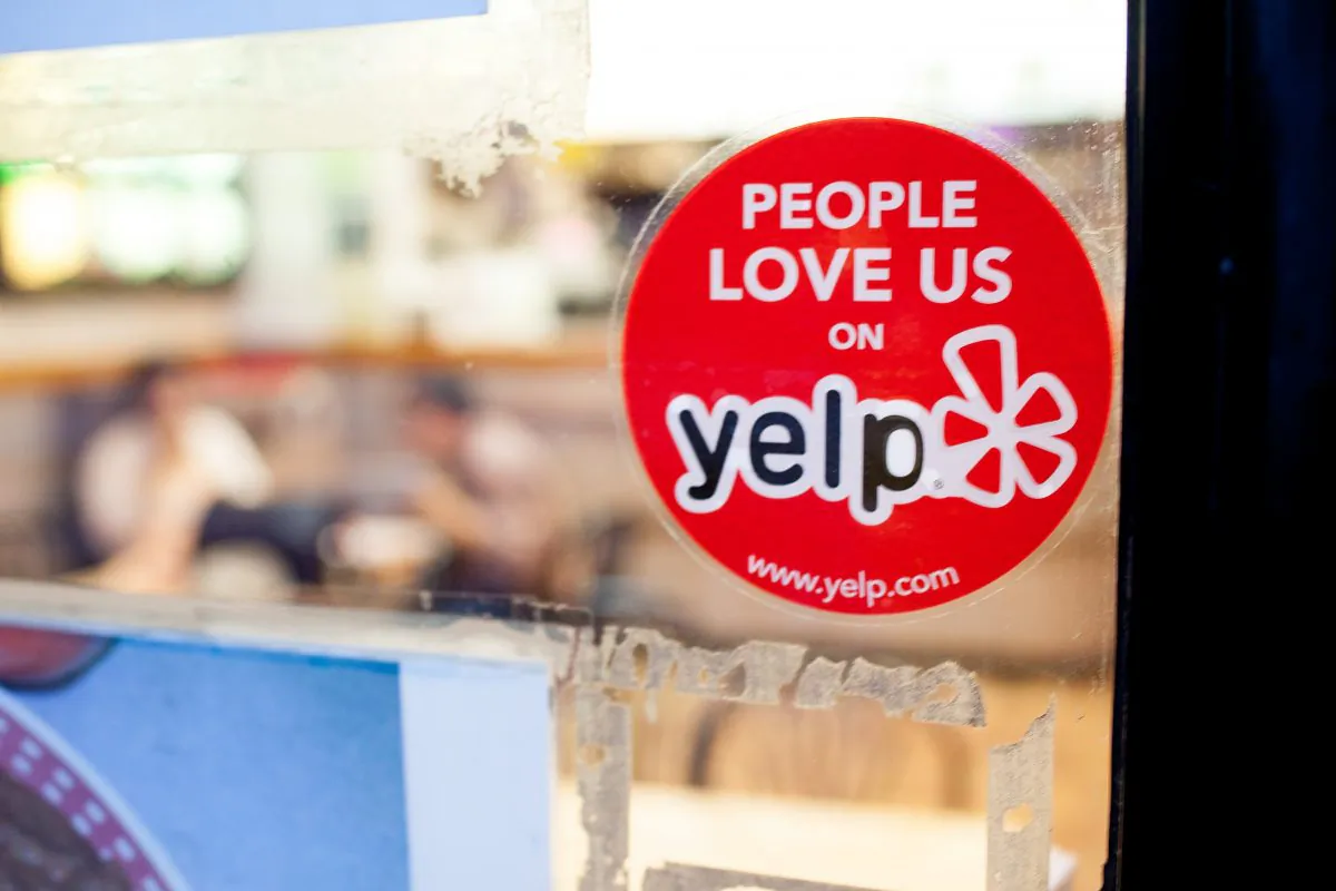 A Yelp sticker on a restaurant in the Chelsea neighborhood of Manhattan in this file photo. (Petr Svab/Epoch Times)