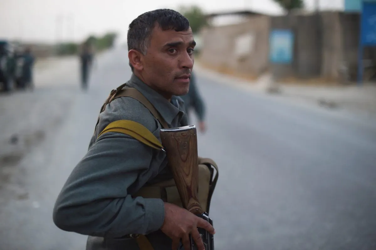 Afghan policemen stand guard at a checkpoint in Kunduz on May 23. The Taliban denied rumors it sent delegates to peace talks in China. (Shah Marai/AFP/Getty Images)