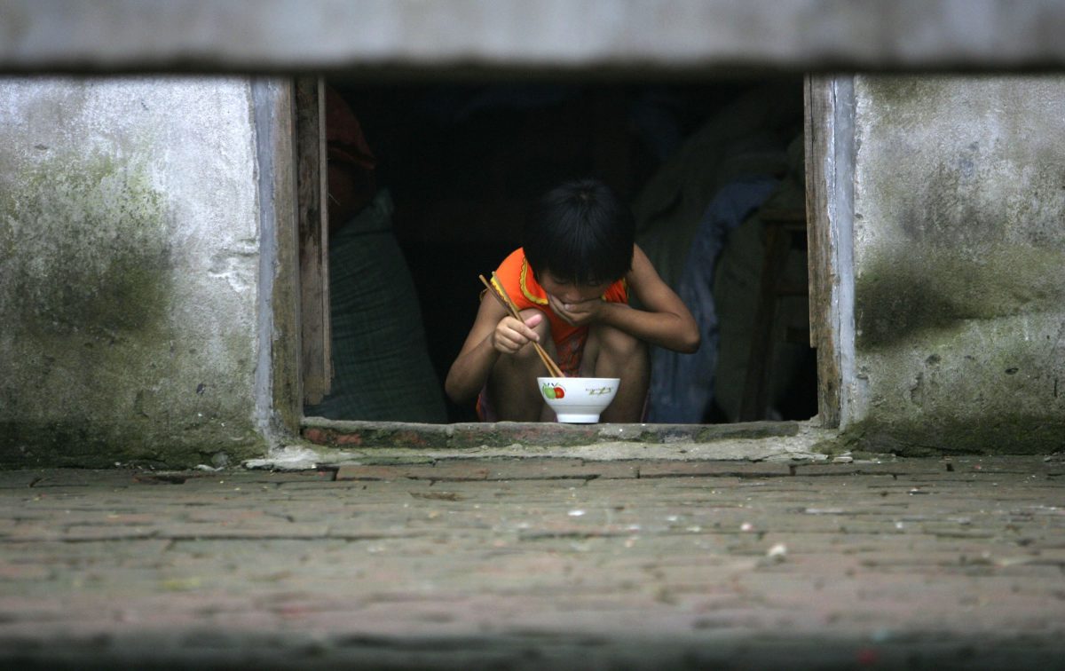 Nine-year-old Ding Shaonan has supper at Wang Jiayu Orphanage of Sanshilipu Village in Yingshang County of Anhui Province. China village child, left by their migrant parents, is subject to series of risk. The rape of minors, including boys, is getting more serious and the age of victims is getting younger. But the draconian law allows Communist perpetrators to avoid their due punishment. (Photo by China Photos/Getty Images)