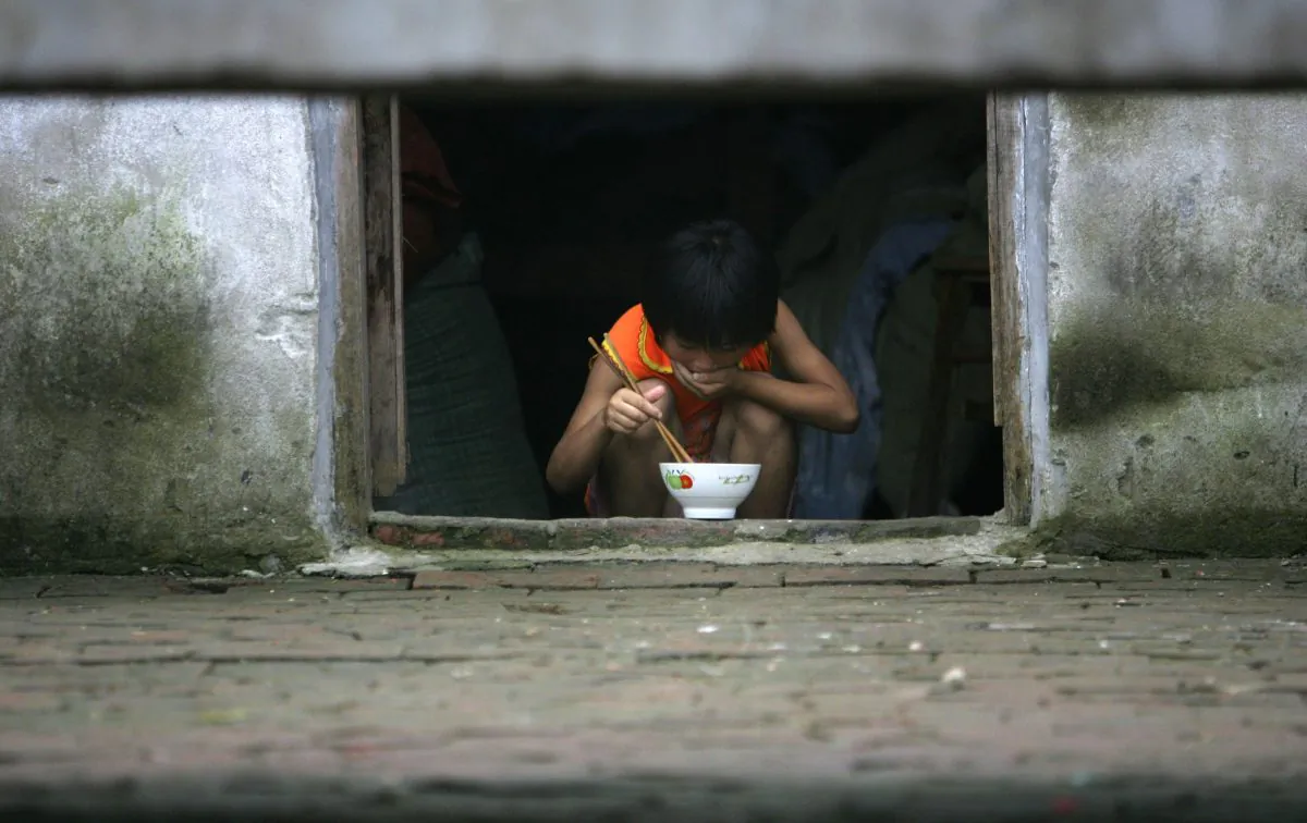 Nine-year-old Ding Shaonan has supper at Wang Jiayu Orphanage of Sanshilipu Village in Yingshang County of Anhui Province. (Photo by China Photos/Getty Images)
