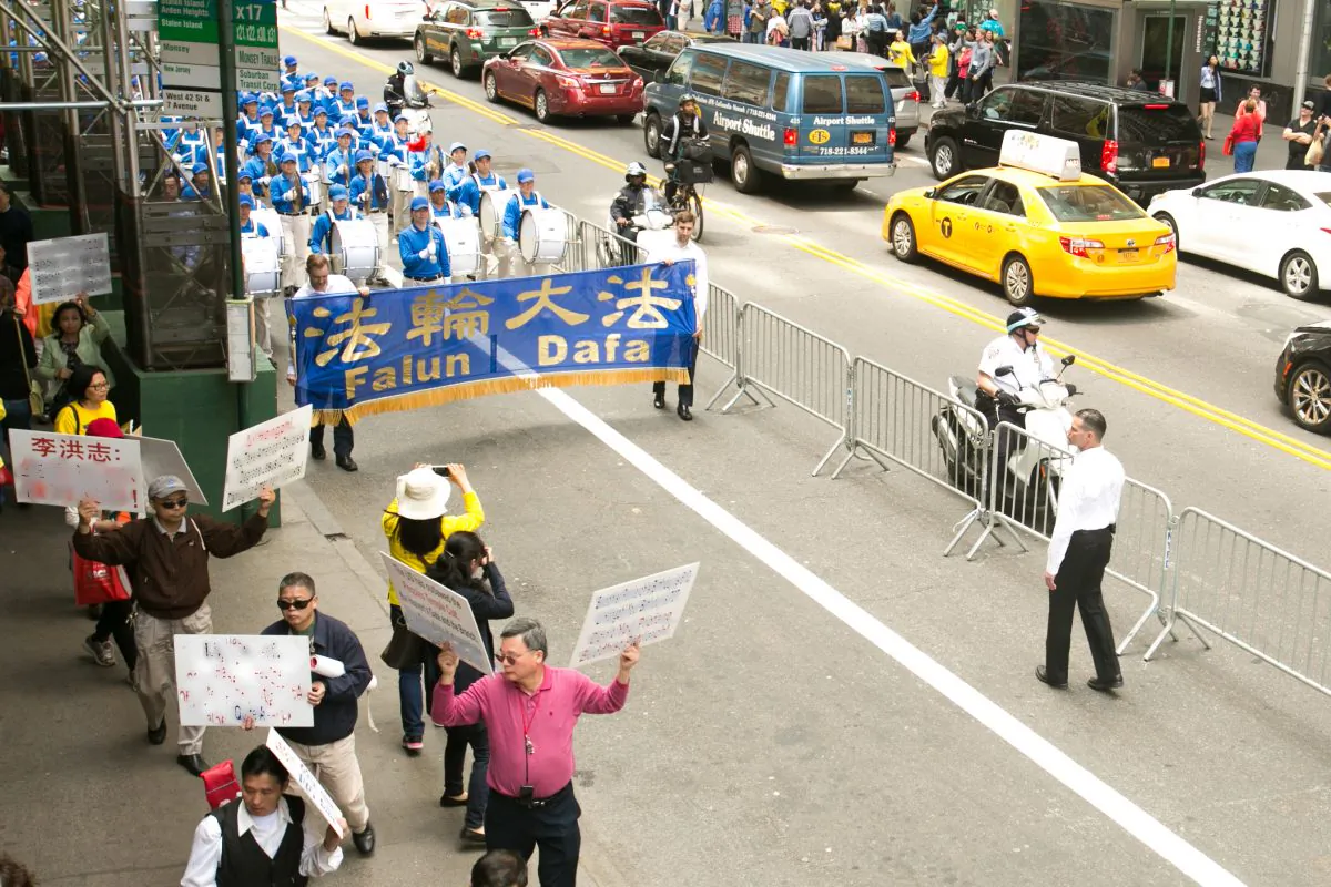 Over 8,000 Falun Gong practitioners participate in a grand parade for World Falun Dafa Day in 42nd Street, as Chinese Communist members walk in front with hate speech against the practice in Manhattan on May 15, 2015. This photo has been modified to remove the hate speech. (Benjamin Chasteen/Epoch Times)