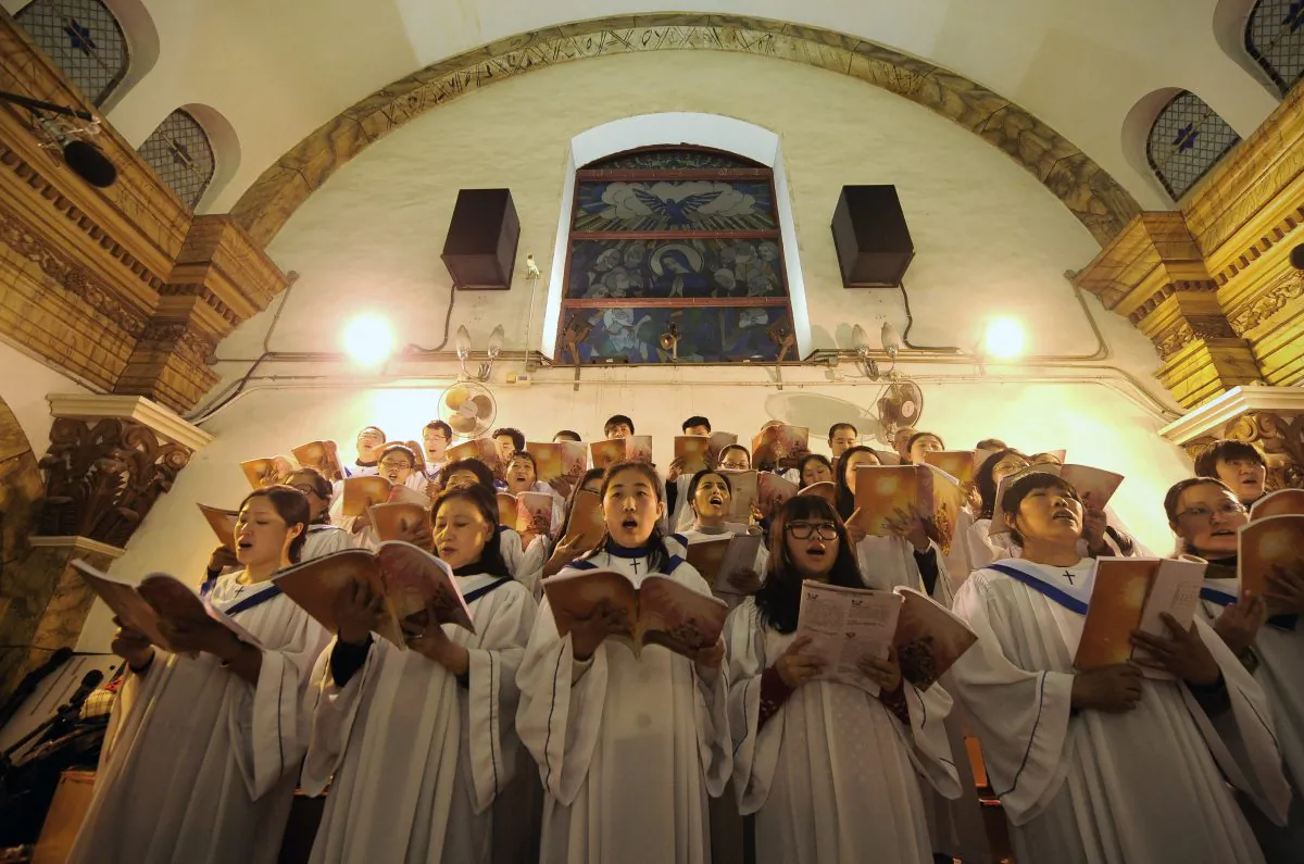 Chinese worshippers sing hymns during the Christmas Eve mass at a state-approved Catholic church in Beijing on Dec. 25, 2012. (Wang Zhao/AFP/Getty Images)