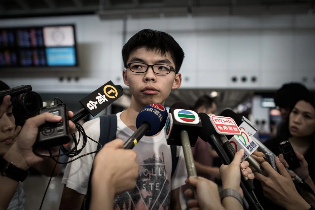 Hong Kong student activist Joshua Wong talks to the media at the international airport in Hong Kong on May 26, 2015. Wong was barred from entering Malaysia at Penang airport on May 26 where he was scheduled to attend forums on June 3, the eve of the 26th anniversary of the Tiananmen Square events in China. (Philippe Lopez/AFP/Getty Images)