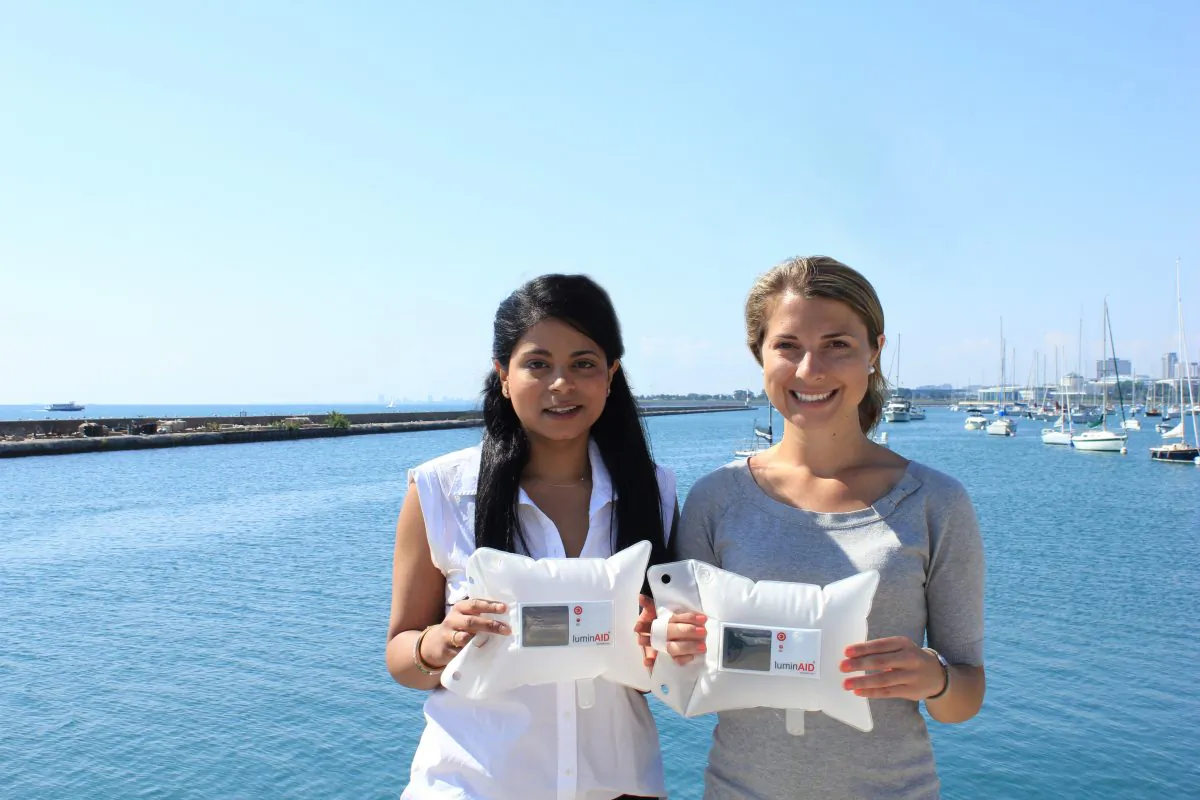 LuminAid co-founders Andrea Sreshta (L) and Anna Stork with their original solar inflatable light. ( )
