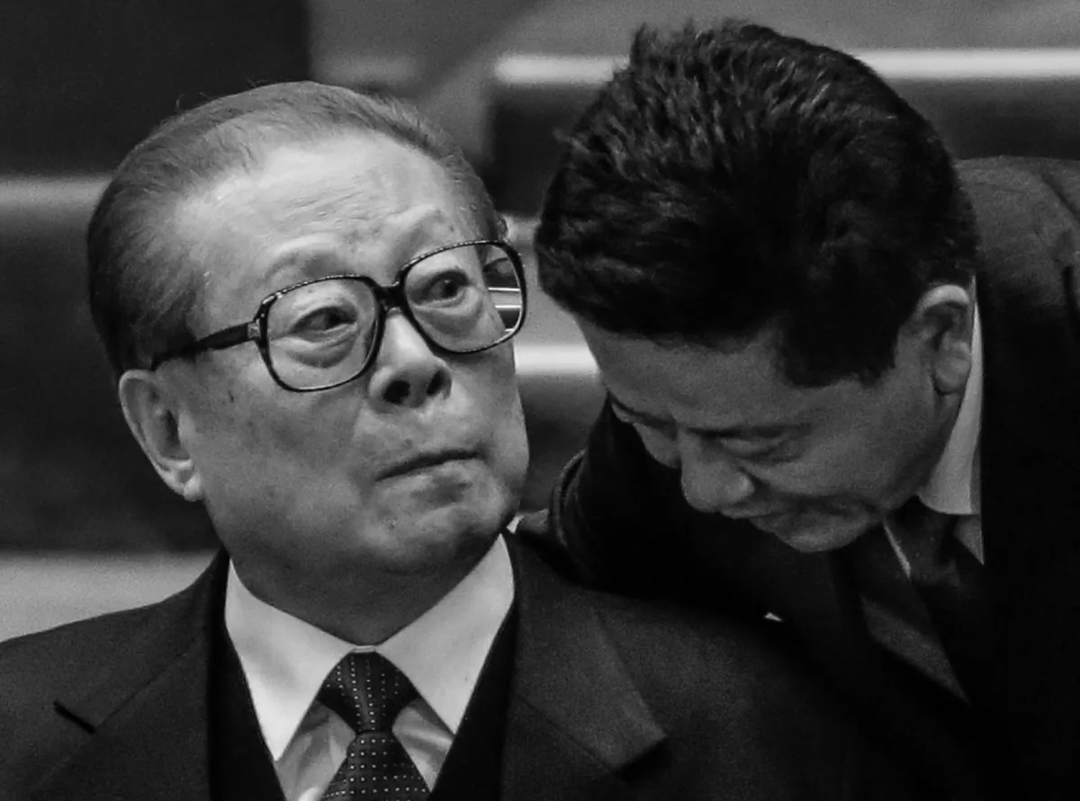 A man speaks to the former Chinese leader Jiang Zemin, during the closing ceremony for the 18th Communist Party Congress at the Great Hall of the People in Beijing on Nov. 14, 2012. (AP Photo/Lee Jin-man)