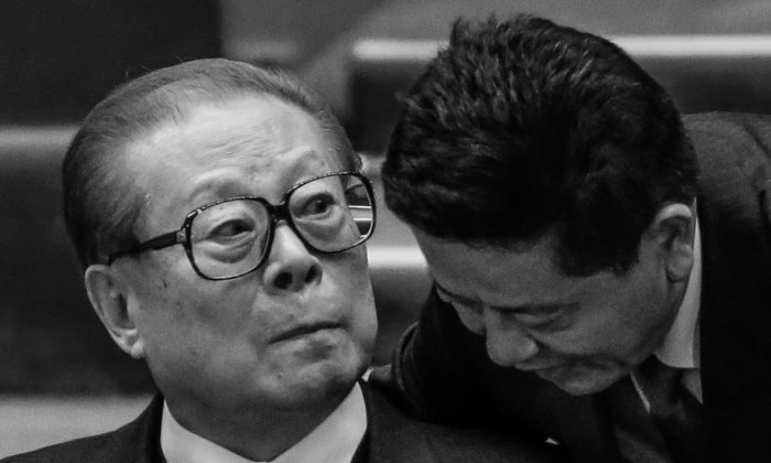 A man speaks to the former Chinese leader Jiang Zemin, during the closing ceremony for the 18th Communist Party Congress at the Great Hall of the People in Beijing on Nov. 14, 2012. (AP Photo/Lee Jin-man)