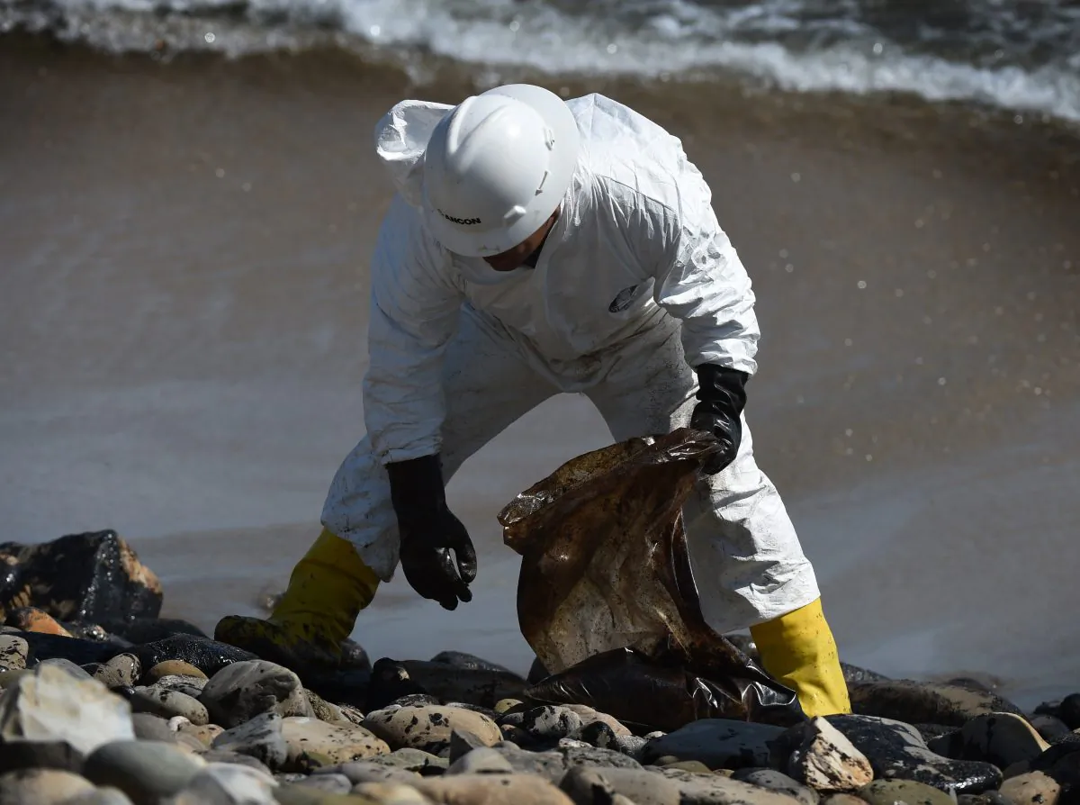 A worker cleans oil from the rocks and beach at Refugio State Beach in Goleta, Calif., near Santa Barbara and northwest of Los Angeles on May 22. (Mark Ralston/AFP/Getty Images) 
