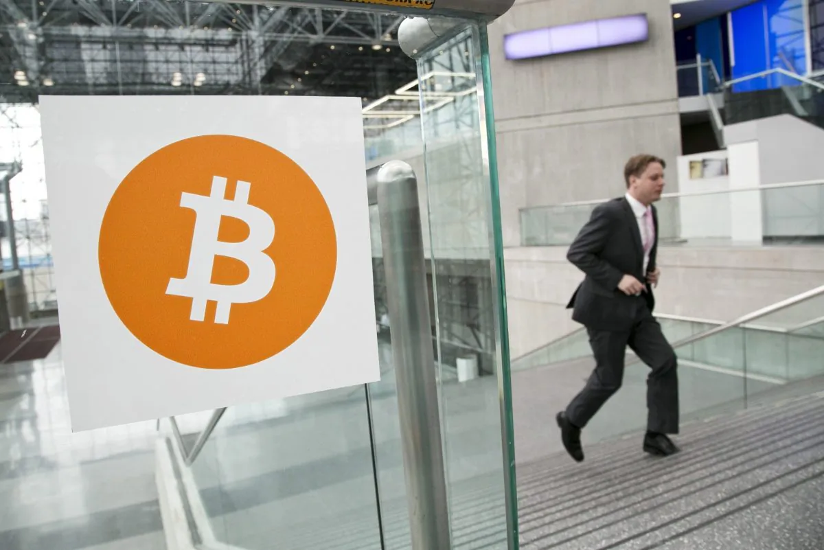 A man arrives for the Inside Bitcoins conference and trade show in New York, April 7, 2014. Simon Fraser University has started accepting Bitcoin at all of its bookstores, in what’s believed to be a first for post-secondary institutions in Canada. (AP Photo/Mark Lennihan, File)
