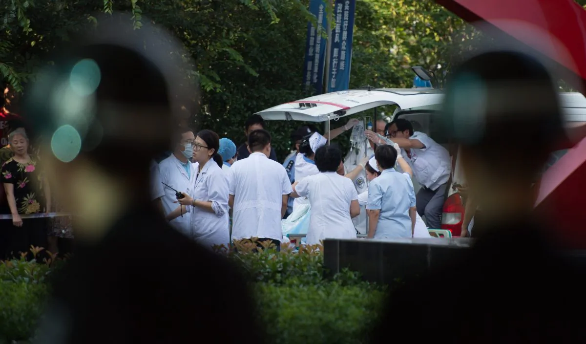 In this file photo, doctors and nurses rush a victim of a factory explosion for treatment at a hospital in China, on August 2, 2014. (Johannes  EiseleE/AFP/Getty Images)