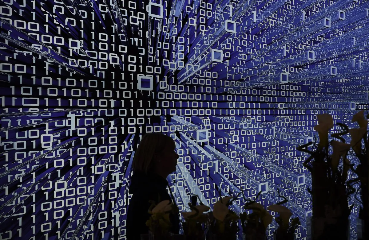 A woman passes a banner at CeBIT technology fair in Hanover on March 15, 2015. (Tobias Schwarz/AFP/Getty Images)