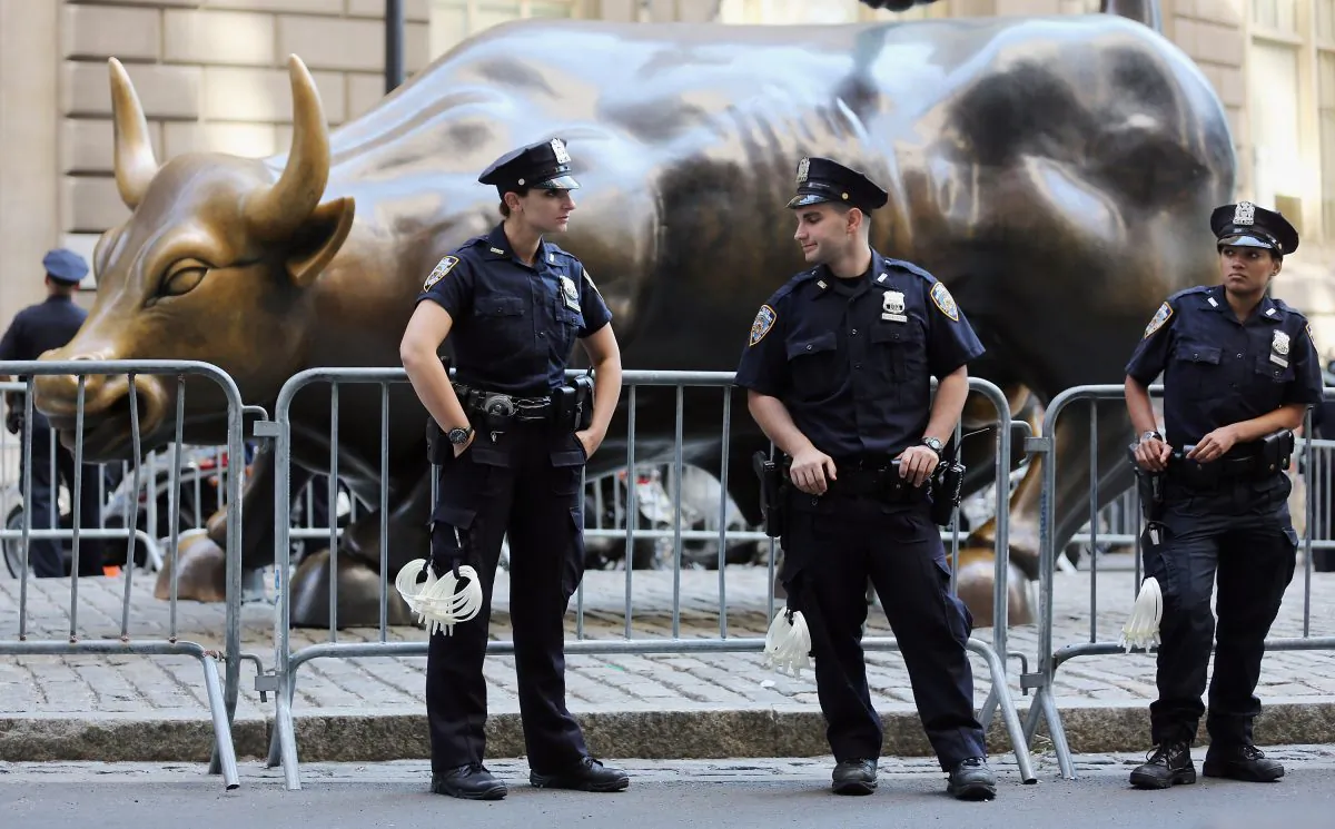 Police guard the famous bull statue during Occupy Wall Street protests in the Financial District in New York on Sept. 17, 2012. Taming the irrational exuberance of bankers is key to avoiding another crisis, argues Anjan V. Thakor. (Mario Tama/Getty Images)