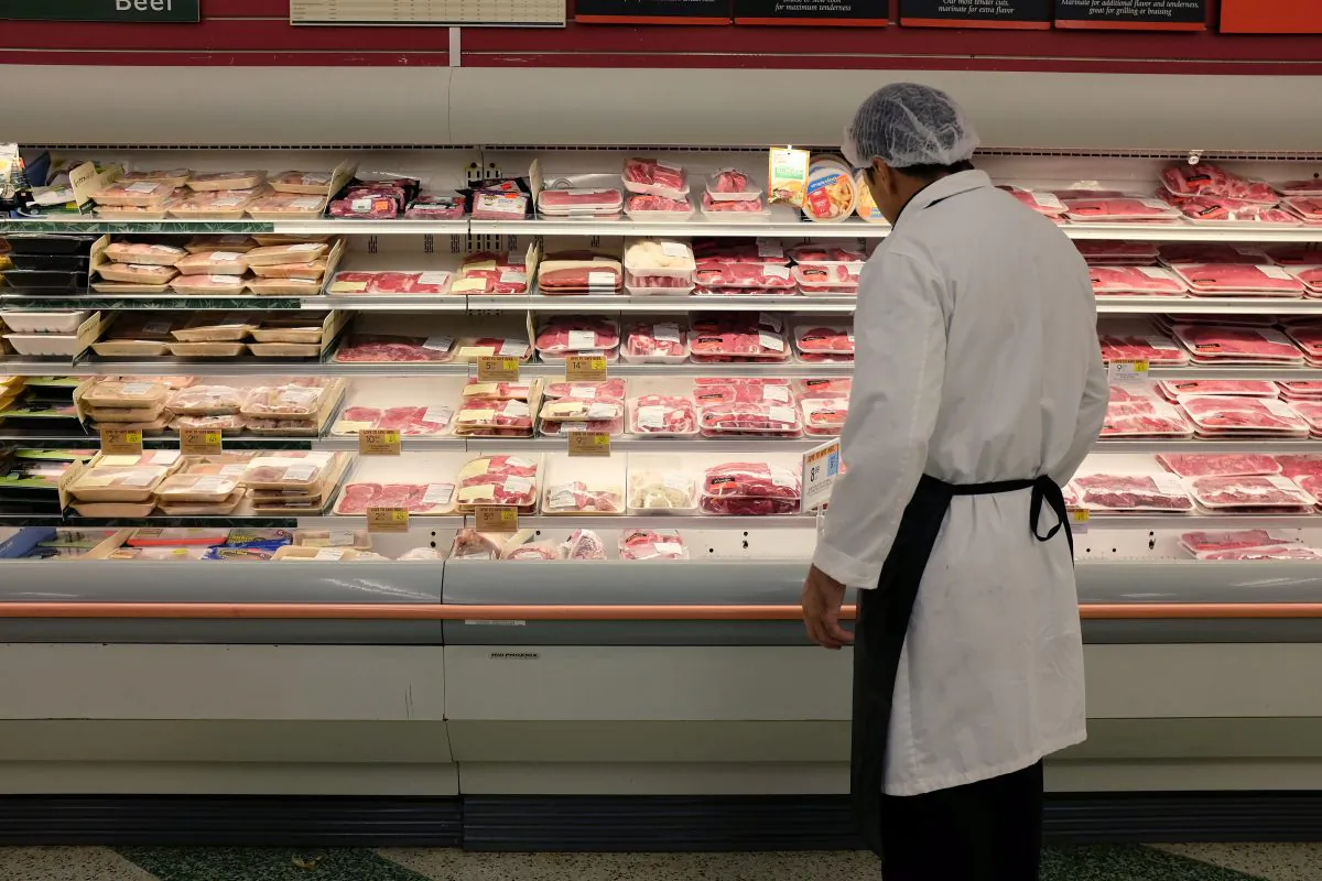 An employee checks up on meat at a grocery store in Miami on July 8, 2014. (Joe Raedle/Getty Images)