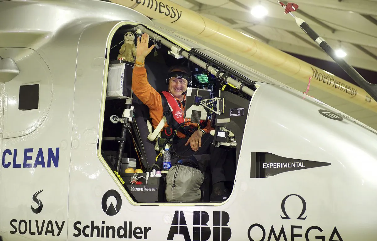 Swiss pilot Andre Borschberg waves from the aircraft Solar Impulse 2 before taking off at Nanjing Lukou International Airport in Nanjing in eastern China's Jiangsu province. (Chinatopix via AP)