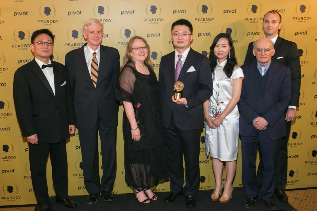 Producer and Director of 'Human Harvest' Leon Lee (fourth from R) holds his award along with his guests during the 74th Annual Peabody Awards Ceremony at Cipriani Wall Street on May 31, 2015 in New York City. (Benjamin Chasteen/Epoch TImes)