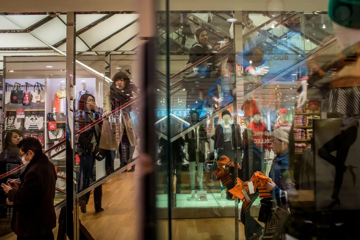 Shoppers browse a clothing store in the Ginza shopping district on February 20, 2015 in Tokyo, Japan. Tourists celebrating the Lunar New Year are visiting Japan, where the weak yen attracts shoppers. With eased visa conditions for Chinese tourists, department stores, hotels and other outlets nationwide are swarming with customers from China, Taiwan and Singapore.  (Photo by Chris McGrath/Getty Images)