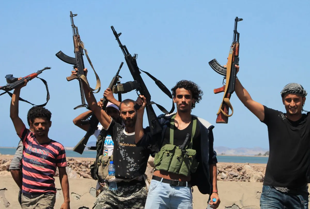 Armed tribal supporters of exiled Yemeni President Abedrabbo Mansour Hadi holds up their weapons as they continue to battle Shiite Huthi rebels for control of the airport and the Khor Maksar neighbourhood of the southern Yemeni city of Aden on May 1, 2015. (Saleh Al-Obeidi/AFP/Getty Images)