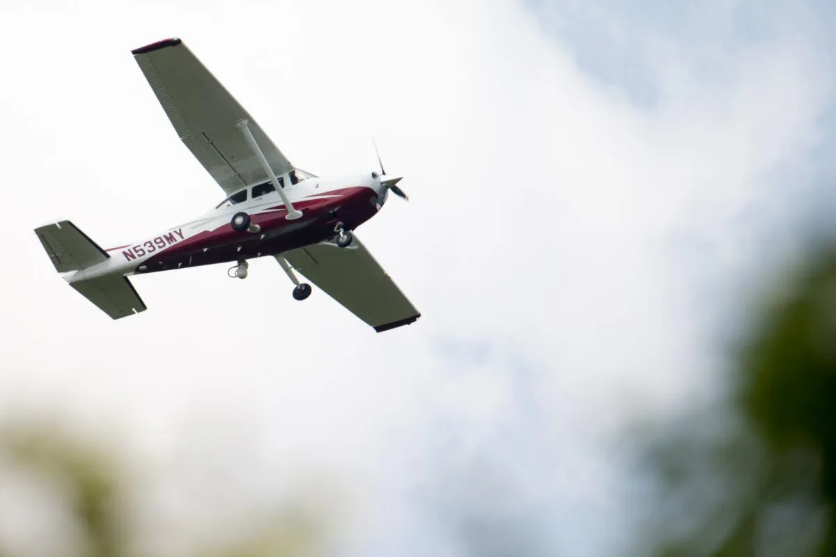 A small plane flies near Manassas Regional Airport in Manassas, Va. The plane is among a fleet of surveillance aircraft by the FBI, which are primarily used to target suspects under federal investigation. Such planes are capable of taking video of the ground, and some—in rare occasions—can sweep up certain identifying cellphone data. (AP Photo/Andrew Harnik)