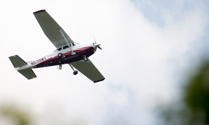 A small plane flies near Manassas Regional Airport in Manassas, Va. The plane is among a fleet of surveillance aircraft by the FBI, which are primarily used to target suspects under federal investigation. Such planes are capable of taking video of the ground, and some—in rare occasions—can sweep up certain identifying cellphone data. (AP Photo/Andrew Harnik)