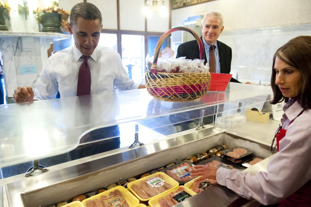US President Barack Obama orders sausages alongside Milwaukee Mayor Tom Barrett (C) during a visit to Usinger's Famous Sausage following campaign events in Milwaukee, Wisconsin, September 22, 2012. (Saul Loeb/AFP/GettyImages)