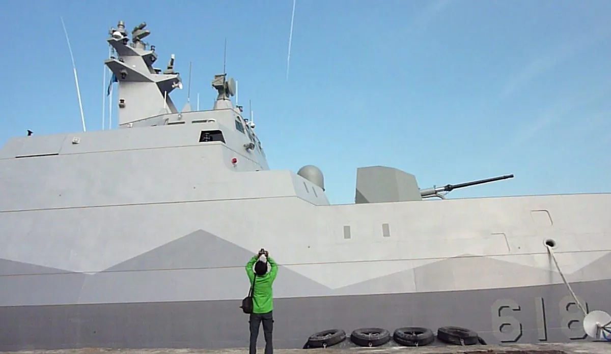 A journalist (C) takes a photo of Taiwan's first domestically-produced missile corvette, the 500-ton ship Tuo Chiang (Tuo River), during the vessel's launch ceremony at the naval port at Suao in northeastern Taiwan's Yilan county on December 23, 2014. (Benjamin Yeh/AFP/Getty Images)