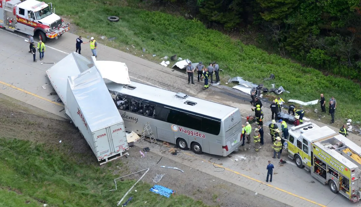 Authorities investigate the scene of a fatal collision between a tractor-trailer and a tour bus on Interstate 380 near Mount Pocono, Pa., Wednesday, June 3, 2015. (AP/David Kidwell)
