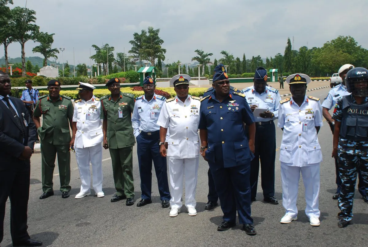Nigeria's chief of defense staff Air Marshal Alex S. Badeh, (foreground third from R), and other military chiefs wait to address the Nigerians Against Terrorism group in Abuja, Nigeria, on May 26, 2014. Nigerian military abuses caused the deaths of some 8,000 people in the fight against Boko Haram extremists, Amnesty International said Wednesday, June. 3, 2015 in a report naming senior officers it wants investigated for alleged war crimes. (AP Photo/Olamikan Gbemiga File)