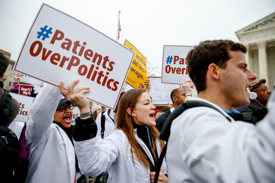 FILE - In this March 4, 2015 file photo, demonstrators chant during health care rally outside the Supreme Court in Washington.  (AP Photo/Andrew Harnik, File)
