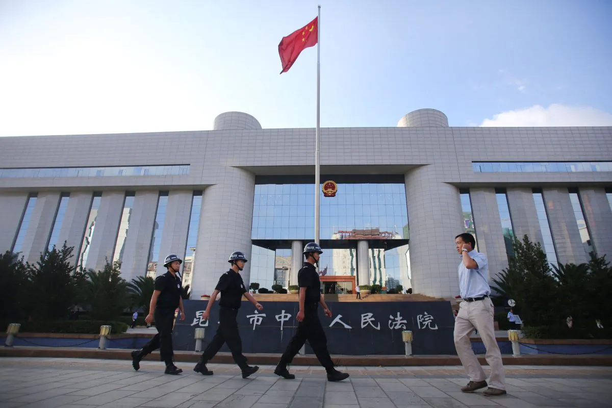 Police patrol at the gate of Kunming's Intermediate Court in Kunming, southwest China's Yunnan province on Sept. 12, 2014. (STR/AFP/Getty Images)
