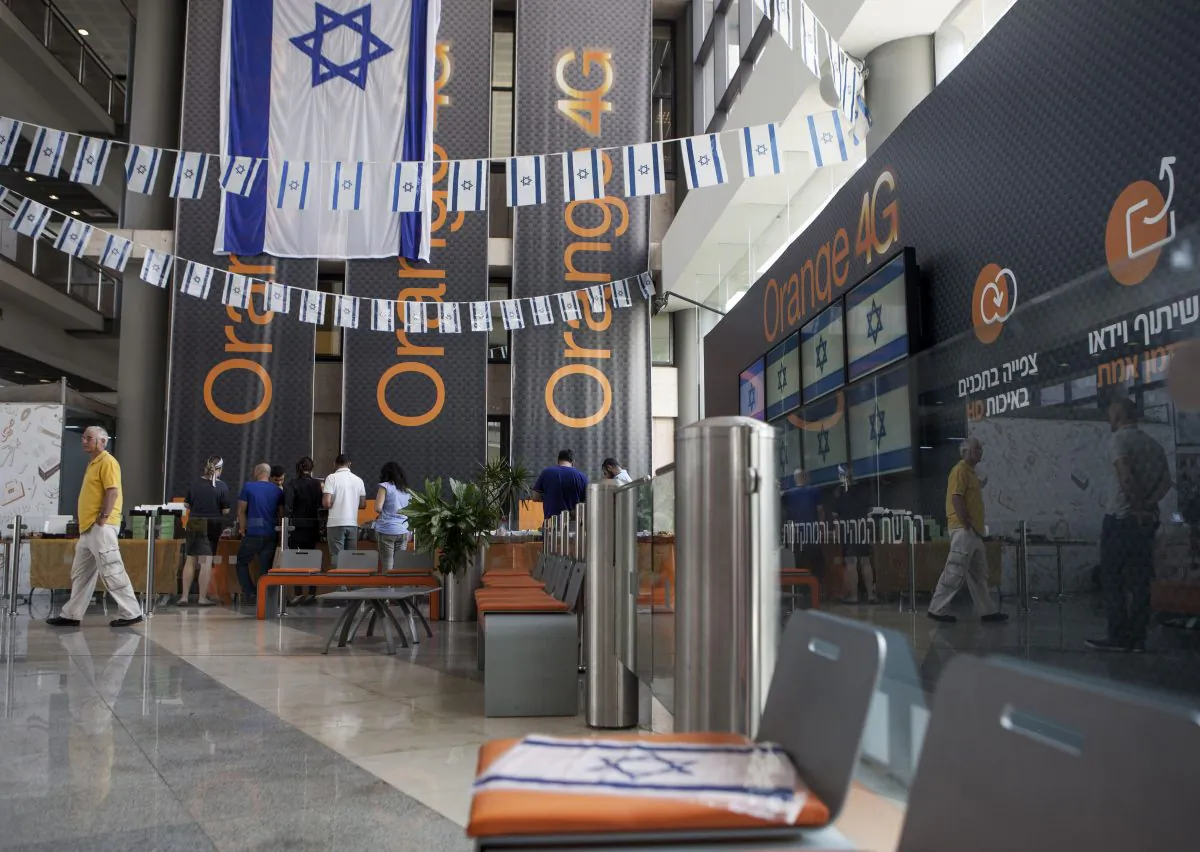Israeli flags are seen inside the "Partner Orange" Communications Company offices in the city of Rosh Haain, Israel, Thursday, June 4, 2015. (AP Photo/Dan Balilty)