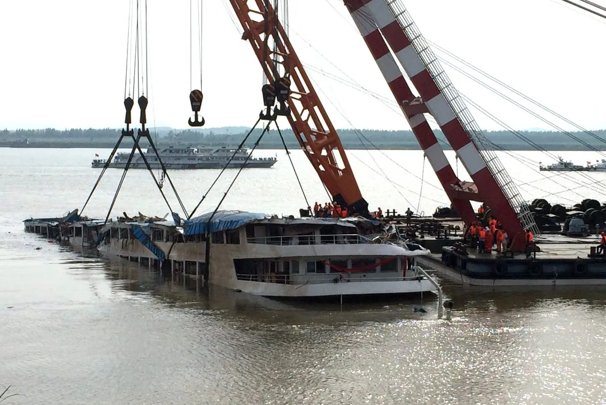 Cranes raise the "Eastern Star" cruise ship after it had previously overturned in a storm on the Yangtze river, off Jianli, in China's Hubei province, June 4, 2015. (STR/AFP/Getty Images)