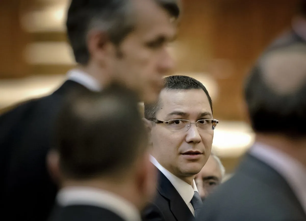Romanian Premier designate Victor Ponta, right, is seen before a parliament session in Bucharest, Romania. (AP Photo/Vadim Ghirda)
