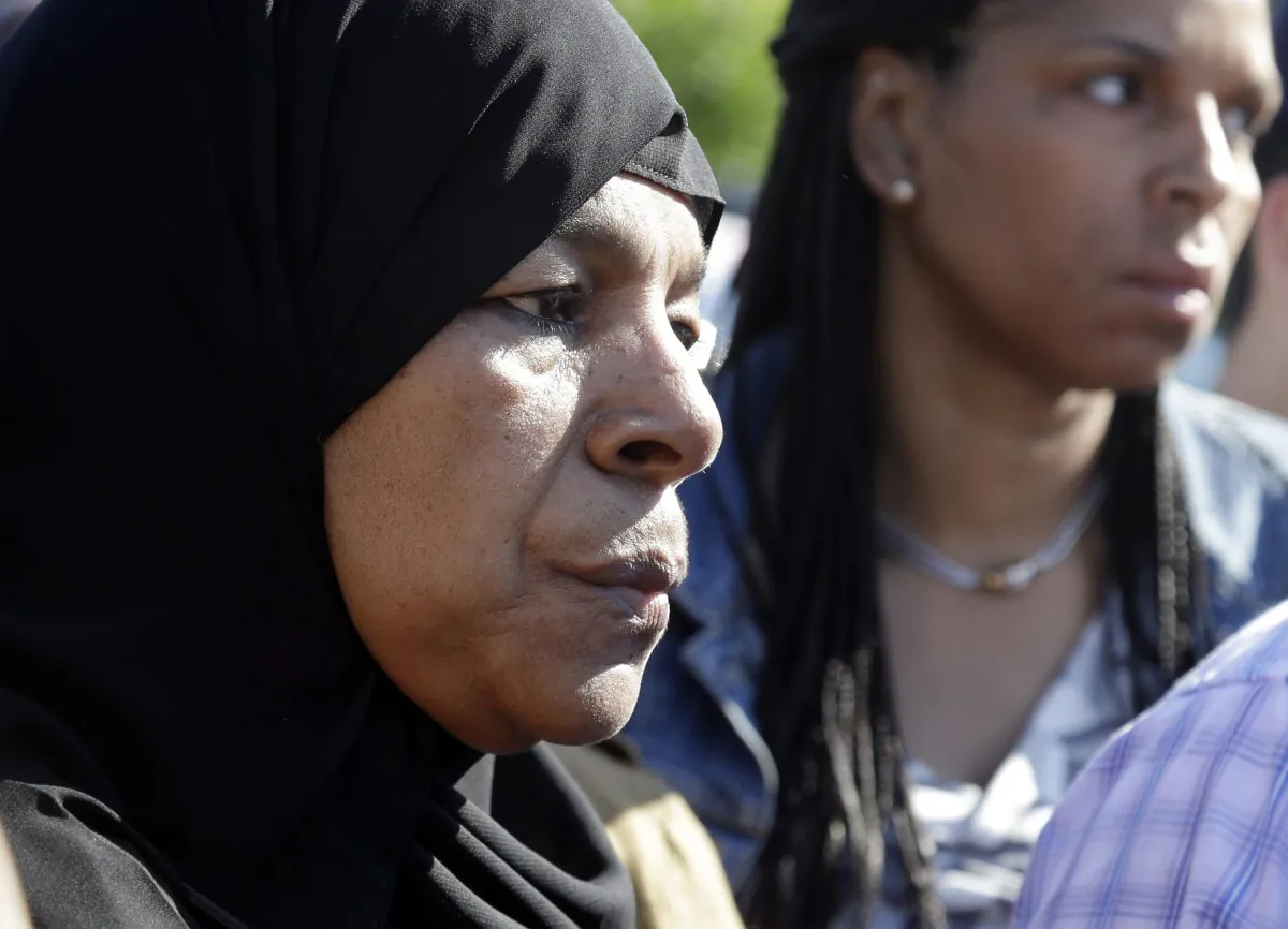 Rahimah Rahim, left, mother of shooting victim Usaama Rahim, listens during a news conference Thursday, June 4, 2015, in Boston's Roslindale neighborhood in the area where Rahim was shot to death. (AP Photo/Elise Amendola)