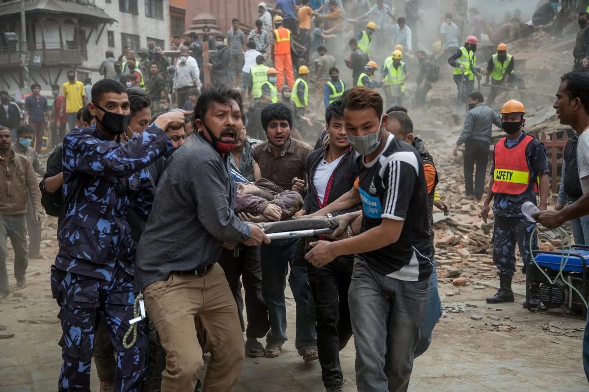Emergency rescue workers carry a victim on a stretcher in Kathmandu, Nepal, on April 25. This earthquake is a warning to the entire Himalaya region, which is vulnerable to disasters caused by earthquakes. (Omar Havana/Getty Images)