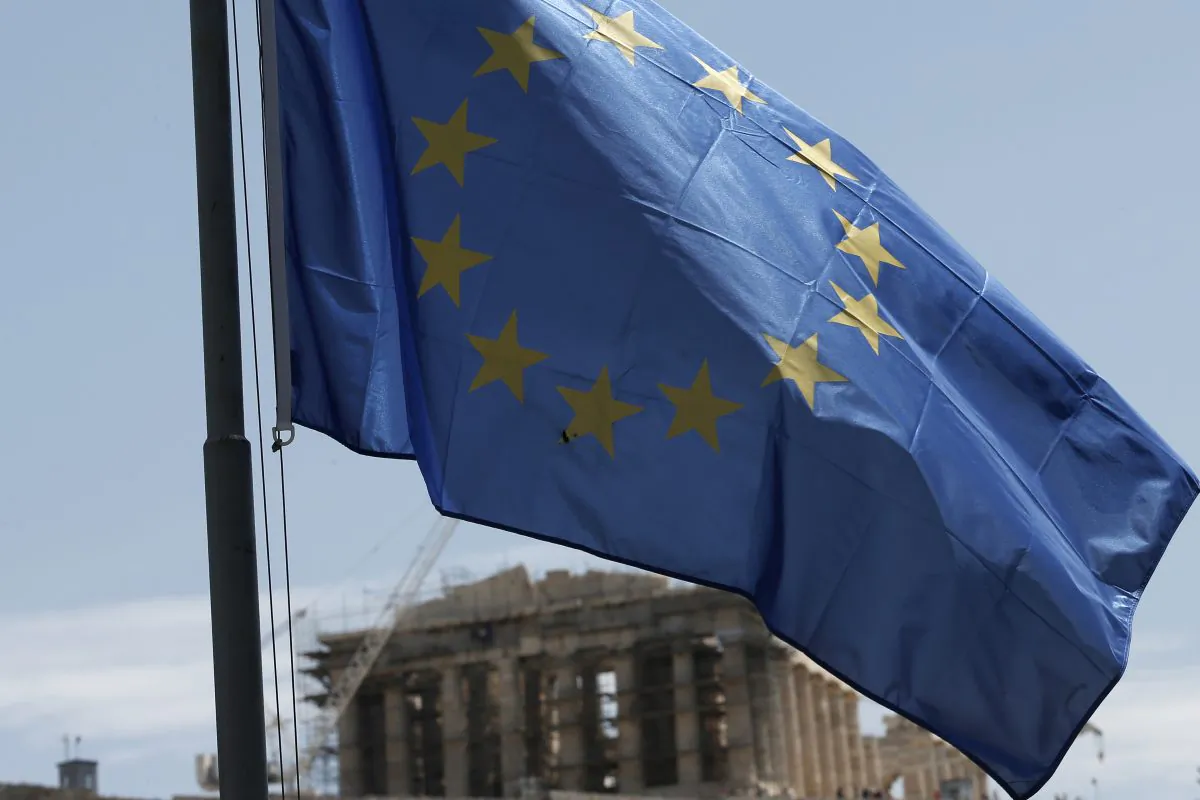 A European Union flag billows in the wind as the ruins of the fifth century BC, Parthenon temple is seen in the background on the Acropolis hill, in Athens, on Wednesday, June 3, 2015. (AP Photo/Petros Giannakouris)