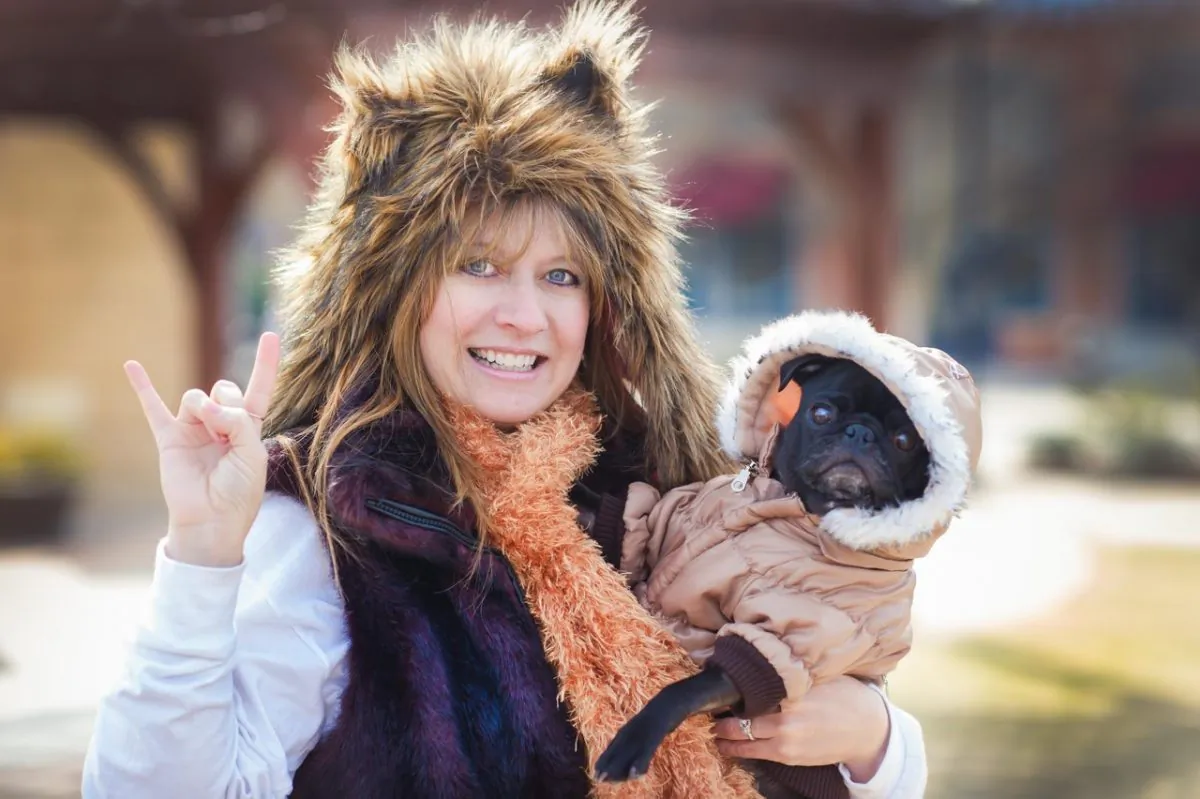 This 2015 photo provided by Amy Breckenridge Smith/AKBS Photo shows, Robin Young holding "Faith" the Pug, a foster dog at The Promenade in Charlotte, N.C. (Amy Breckenridge Smith/AKBS Photo via AP)