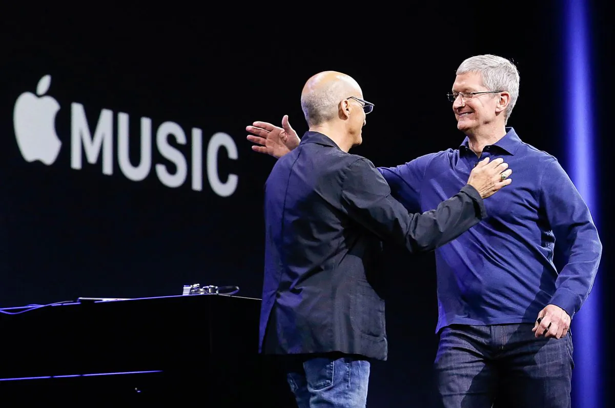 Apple CEO Tim Cook, right, hugs Beats by Dre co-founder and Apple employee Jimmy Iovine at the Apple Worldwide Developers Conference in San Francisco, Monday, June 8, 2015. (AP Photo/Jeff Chiu)