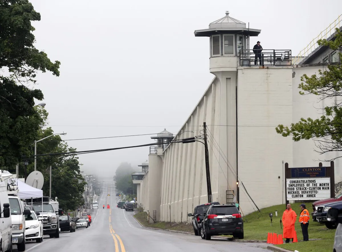 A guard stands on the wall at Clinton Correctional Facility on Monday, June 8, 2015, in Dannemora, N.Y. Two murderers who escaped from the prison by cutting through steel walls and pipes remain on the loose Monday as authorities investigate how the inmates obtained the power tools used in the breakout. (AP Photo/Mike Groll)