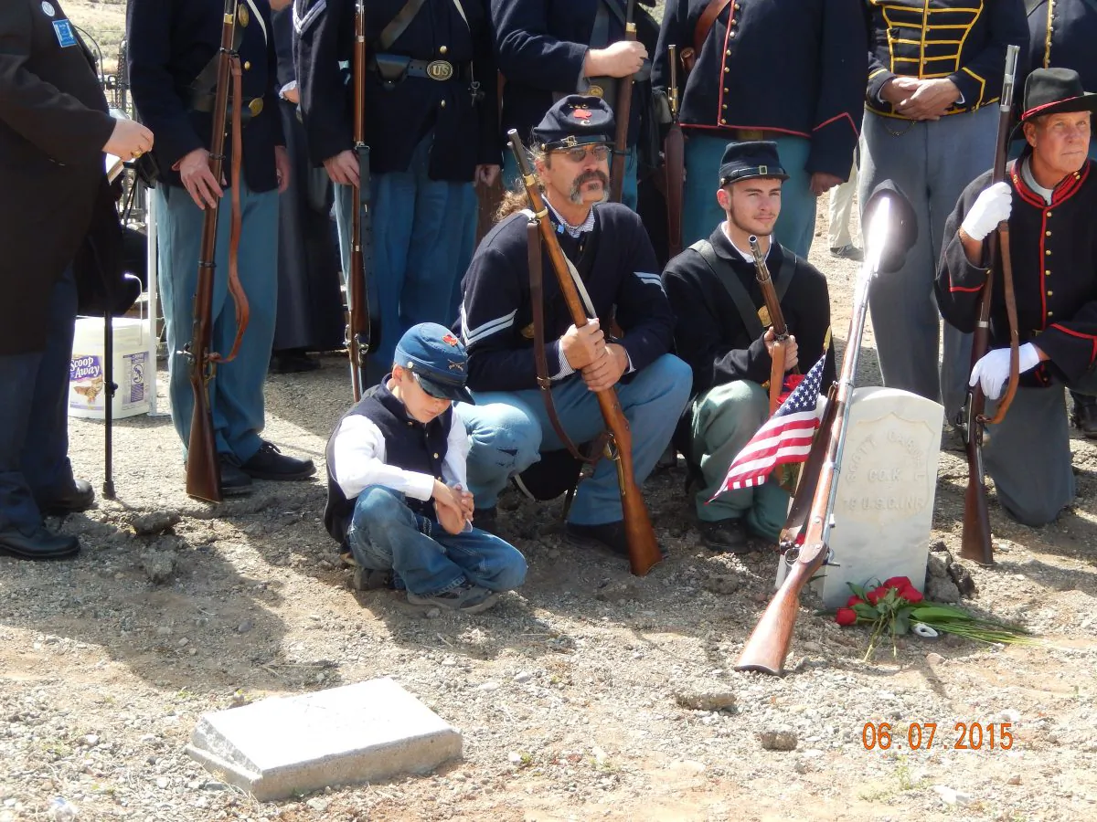 Civil War re-enactors gather Sunday, June 7, 2015, around the grave of Pvt. Scott Carnal of the 1st Kansas Colored Infantry during a ceremony Sunday in Dayton, Nev., 30 miles south of Reno. (Lynne Ballatore/Historical Society of Dayton Valley, via AP)